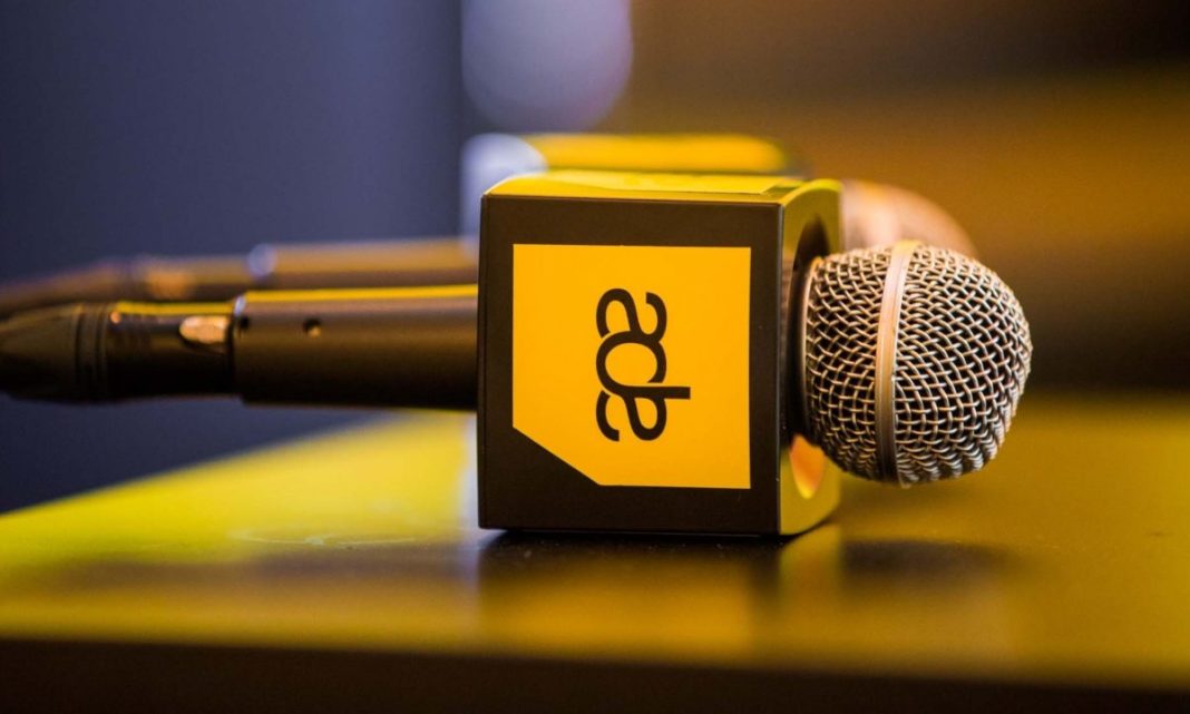 Microphones with Amsterdam Dance Event logo on a table