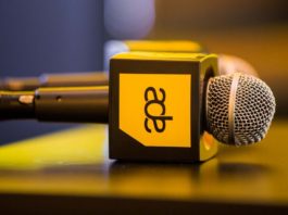 Microphones with Amsterdam Dance Event logo on a table