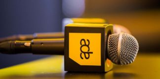 Microphones with Amsterdam Dance Event logo on a table