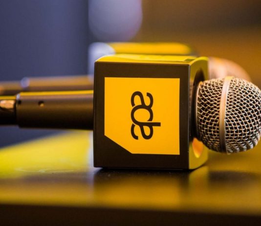 Microphones with Amsterdam Dance Event logo on a table